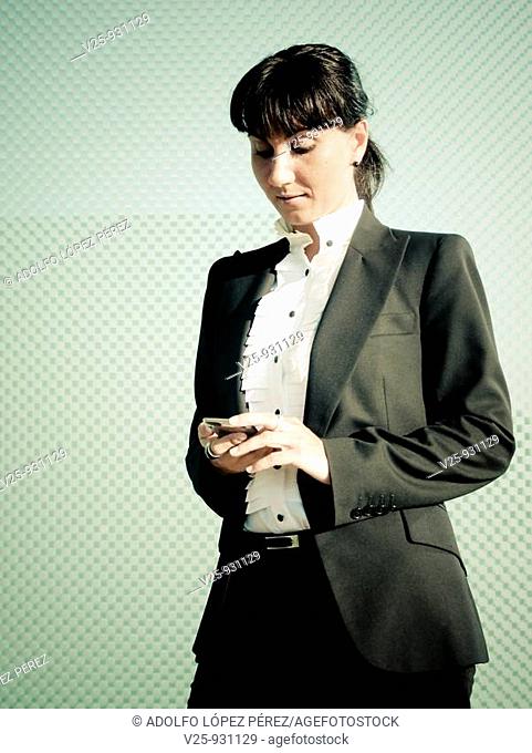 Businesswoman looking at cell phone