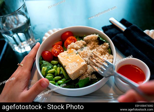 Healthy breakfast bowl with porridge and fresh vegetable salad