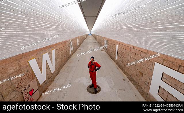 22 December 2021, Saxony, Chemnitz: Artist Anke Neumann stands in the newly designed pedestrian tunnel at Chemnitz central station