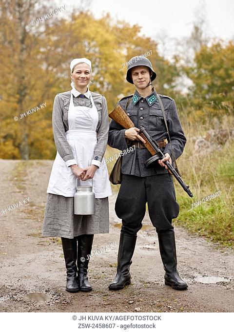 Historic costume theme World War II, Finnish soldier and the Lotta. Photographed in the Ragvalds museum area in Kirkkonummi, Finland