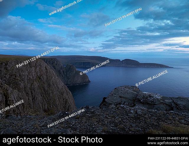 24 August 2023, Norway, Nordkapp: Rocks and cliffs near the North Cape Horn, taken in the early morning from the shale plateau of the North Cape