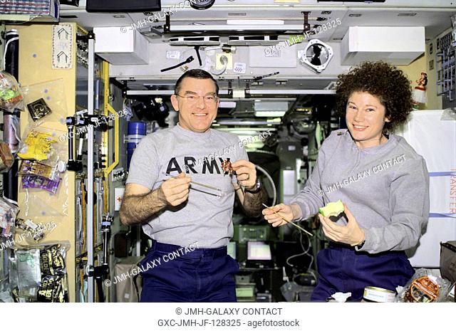 Astronauts James S. Voss and Susan J. Helms take a snack break in the Zvezda Service Module. The Expedition Two flight engineers were captured with a digital...