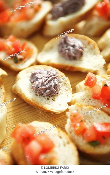 Canapes with tomatoes and olive cream