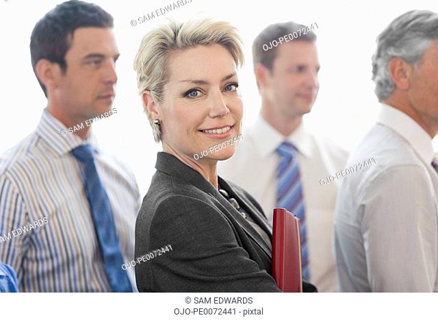 Smiling businesswoman with businessmen