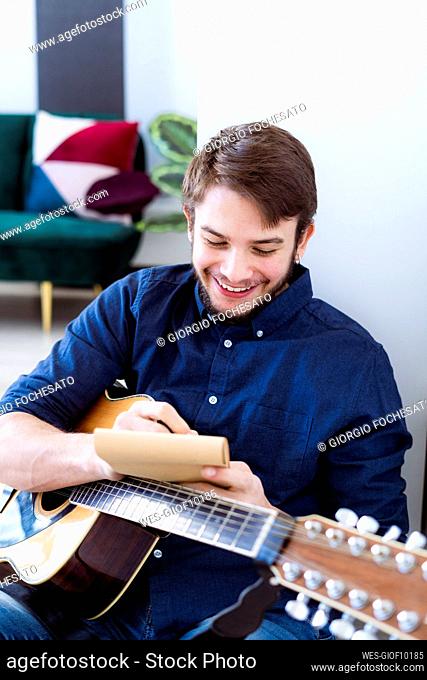 Musician smiling while composing music at studio