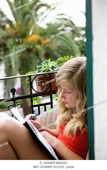Girl sitting and writing diary