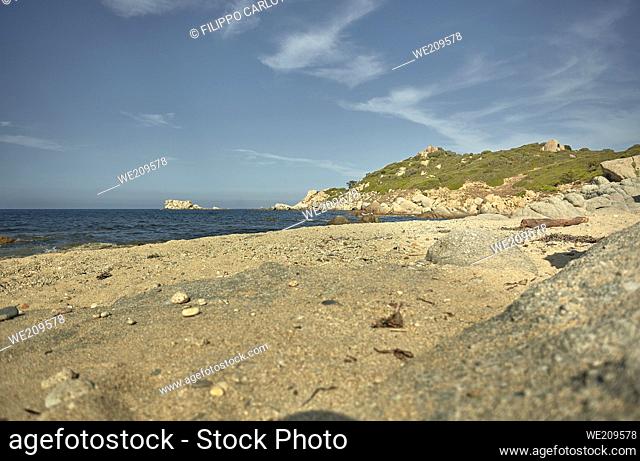 Beautiful Mediterranean beach typical of the coast of southern Sardinia taken over in summer. The beach, the rocks and the mountains behind blend in a wonderful...