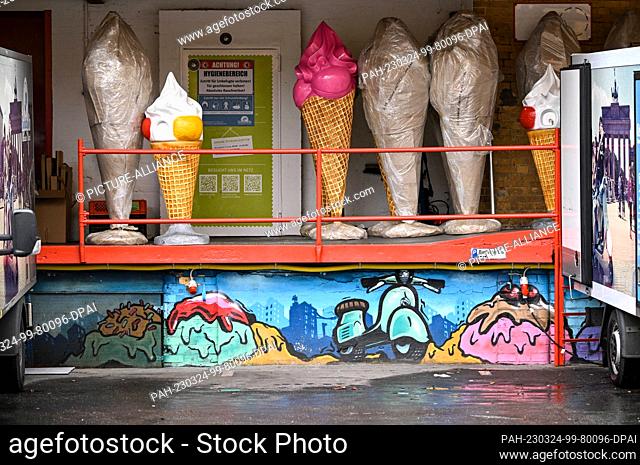 01 February 2023, Berlin: Large ice cream cones stand in a courtyard in Kreuzberg, waiting to be delivered and used as advertising displays