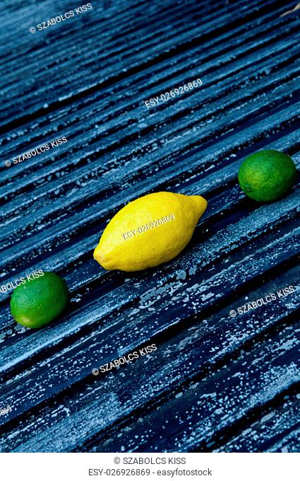 Raw textured black Background backdrop with lemon and lime and copy space outdoor