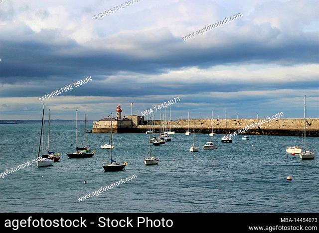 View of lighthouse, boats in Dun Laoghaire, county Dublin, Ireland, thunderstorm atmosphere