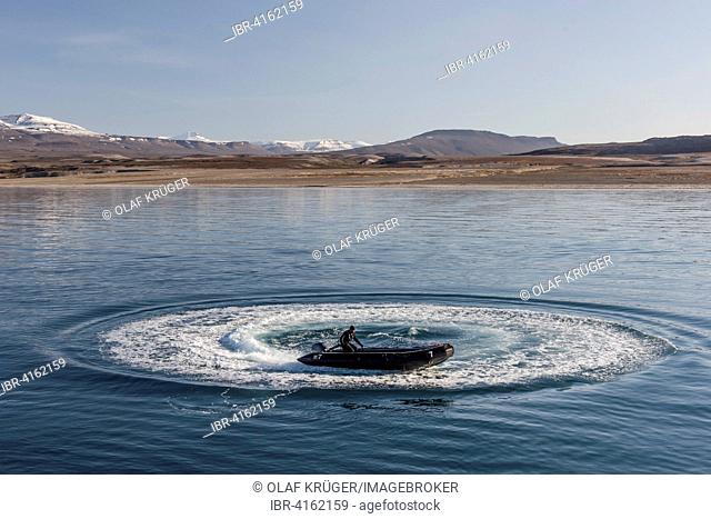 Guide in a Zodiac inflatable boat, Holmbugt, Kong Oscar Fjord, Northeast Greenland National Park, Greenland