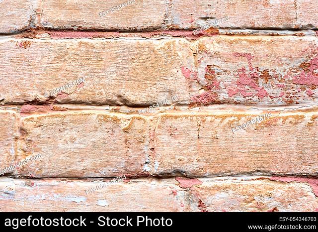 Close-up Textured background of multi-layer flaking paint on the wall. Mixing different colors of paints in the cleaved layers on the surface