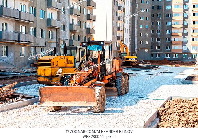SAMARA, RUSSIA - MAY 29, 2016: Grader works on laying gravel on the road at the construction site