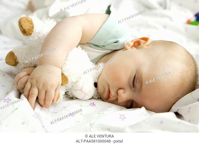 Infant sleeping with stuffed toy