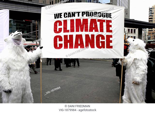 CANADA, TORONTO, 24.01.2010, Protestors in polar bear suits hold a sign to try to persuade the Canadian government to take action on the issues of climate...