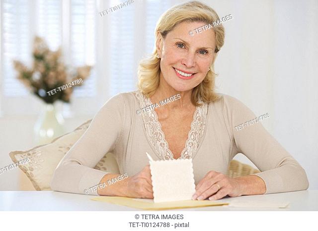 Senior woman writing card