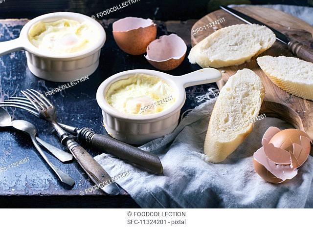 Baked eggs with bread and vintage cutlery