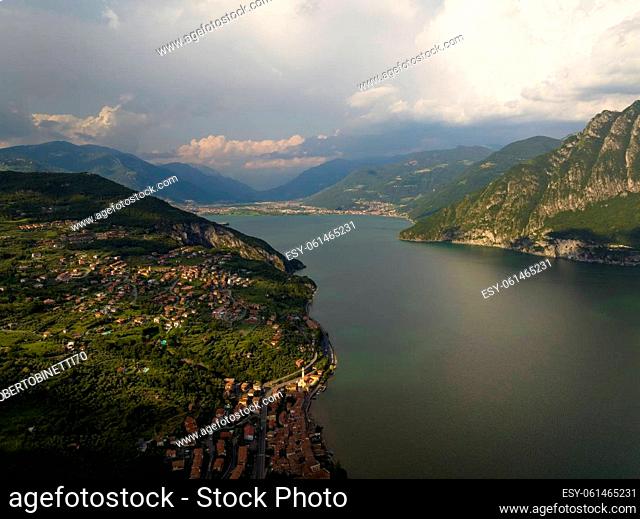 Aerial view of Iseo lake and mountains around at sunny day with clouds. Bergamo, Lombardy, Italy