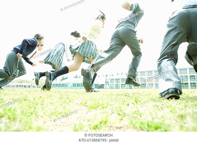 High school students running on lawn