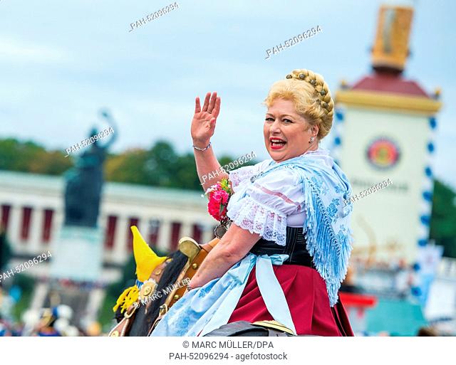 The 'Bräurosl' participates in the costume and shooting club parade at the Oktoberfest in Munich (Bavaria), Germany, 21 September 2014
