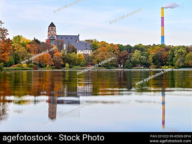 22 October 2020, Saxony, Chemnitz: The castle church and the chimney of the thermal power station, designed by the French painter Daniel Buren