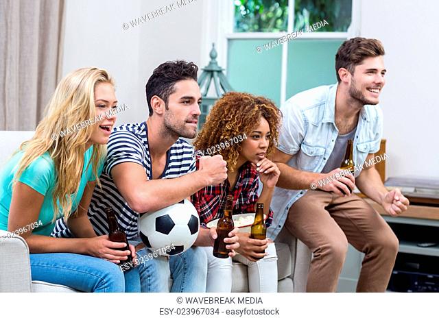 Multi-ethnic friends watching soccer match