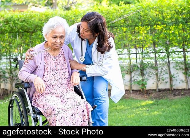 caregiver help and care Asian senior woman patient sitting on wheelchair at nursing hospital ward, healthy strong medical concept