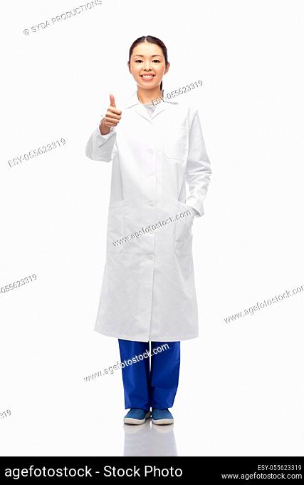 smiling asian female doctor showing thumbs up