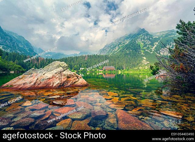 Popradske pleso in the High Tatras Mountains, Slovakia. Charming High Tatras with a forest on the slopes of the mountains and a hotel on the shore of the lake