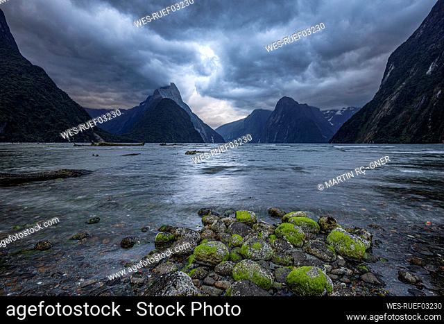 New Zealand, Fiordland, Storm clouds over scenic coastline of Milford Sound