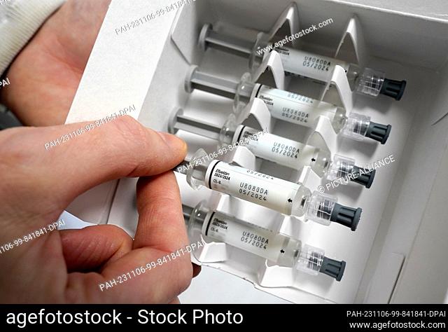 06 November 2023, Hamburg: A doctor pulls a vaccine dose from a package containing the Efluelda vaccine, a flu vaccine for people aged 60 and over