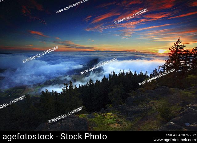 Sunset Over Fog Rolling in Over Puget Sound and The San Juan Islands From The Summit of Mt Erie on Fidalgo Island in Washington