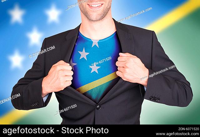 Businessman opening suit to reveal shirt with flag, Solomon Islands