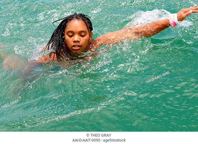 School girl swimming freestyle in pool, St Mark's School, Mbabane, Hhohho, Kingdom of Swaziland