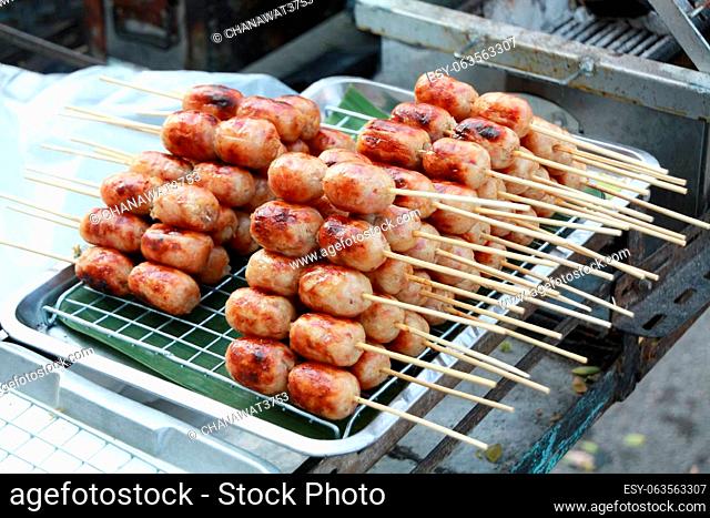 Isaan Sausage, a very popular street food in Thailand. Easy to buy, cheap price, delicious taste made from pork stuffed with sour seasoned rice and pork