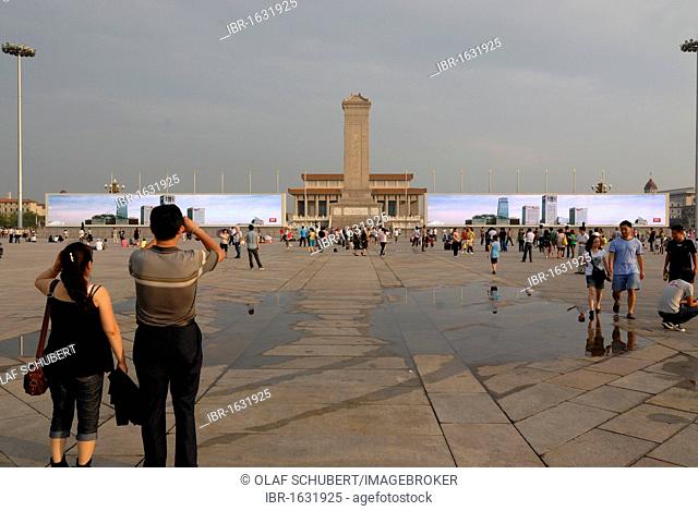 Chinese visitors standing in front of a huge multimedia presentation at the Mao Zedong Mausoleum on Tiananmen Square, Tianamen, Beijing, China, Asia