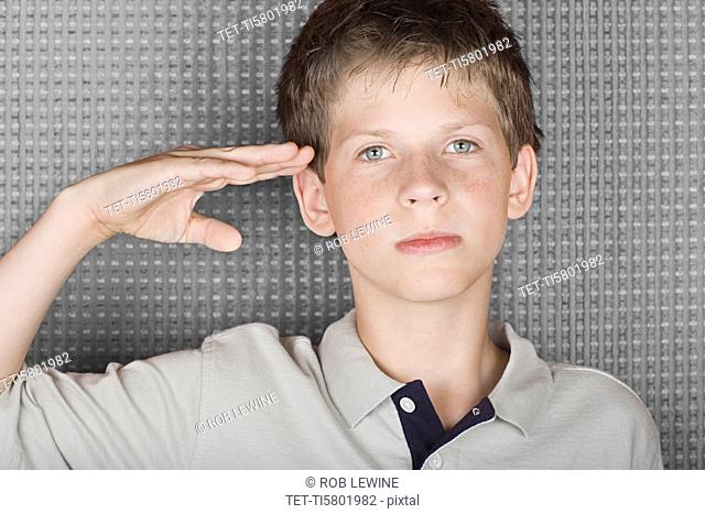 Portrait of saluting boy
