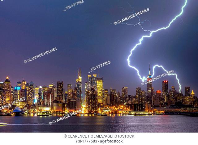 A large cloud to ground forked lightning bolt strikes the ground in New York City during a summer thunderstorm on Thursday, July 26, 2012