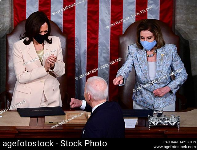 US President Joe Biden gestures to US Vice President Kamala Harris and Speaker of the United States House of Representatives Nancy Pelosi (D-CA) after he...