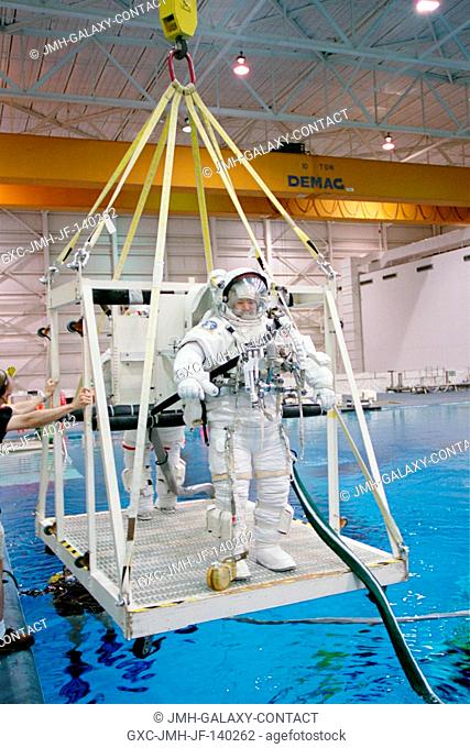Astronaut Soichi Noguchi and Stephen K. Robinson, (partially obscured), both STS-114 mission specialists, are about to be submerged in the waters of the Neutral...