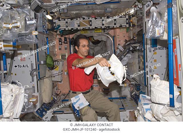 NASA astronaut Joe Acaba, Expedition 32 flight engineer, works with a stowage container in the Unity node of the International Space Station