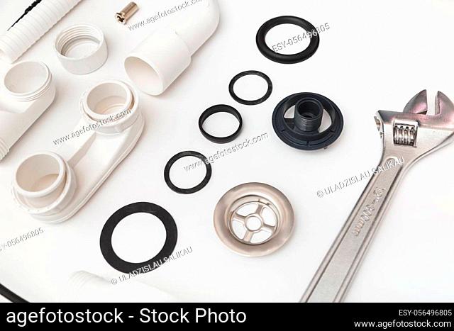 Details plastic siphon kit for bathtub on a white background. Plumbing knolling on white background