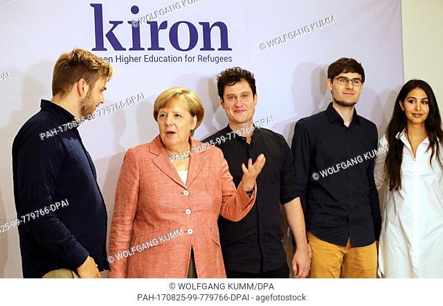 German Chancellor Angela Merkel visiting the Berlin start-up Kiron and being briefed on the company's work by employees Vincent Zimmer (left to right)