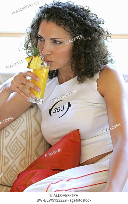 woman drinking a glass of fruit juice