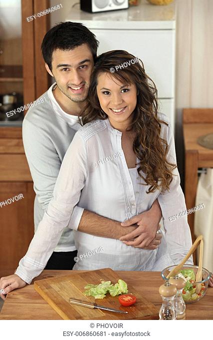Couple preparing a meal together in their kitchen