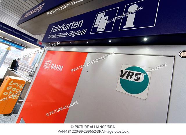 19 December 2018, North Rhine-Westphalia, Köln: A logo from Verkehrsverbund Rhein-Sieg is stuck to a ticket machine at Hansaring station