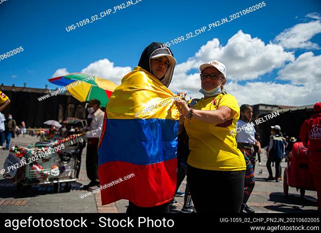 A mother suits up her son with a Colombian flag at Plaza de Bolivar as Colombians demonstrate a t the start of the fifth week of anti-government protests...