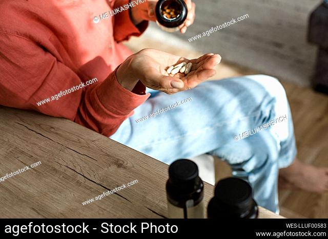 Woman pouring pills into her hand
