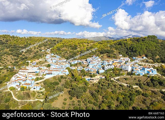 The village of Júzcar above the Genal river valley, the houses of this former White Village have been painted in smurf-blue to celebrate the premiere of the...