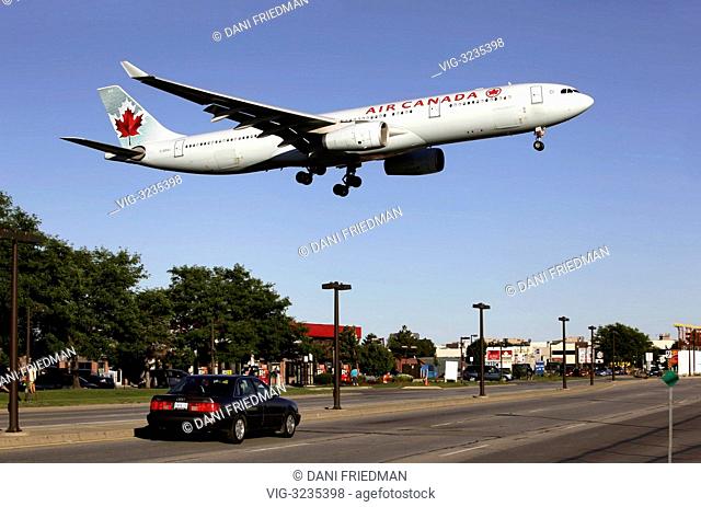 A low flying Air Canada Airlines Airbus A330-343X airplane coming in for a landing at Lester B. Pearson International Airport in Ontario, Canada